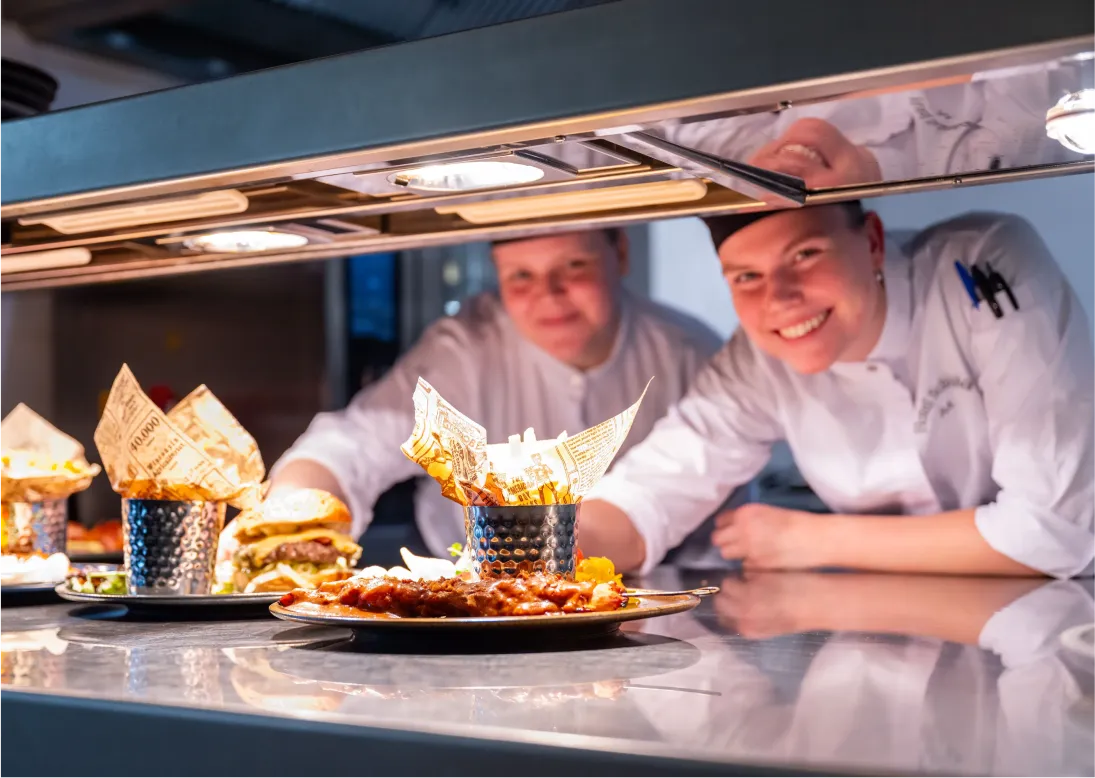 Corporate photo of hospitality staff preparing dishes