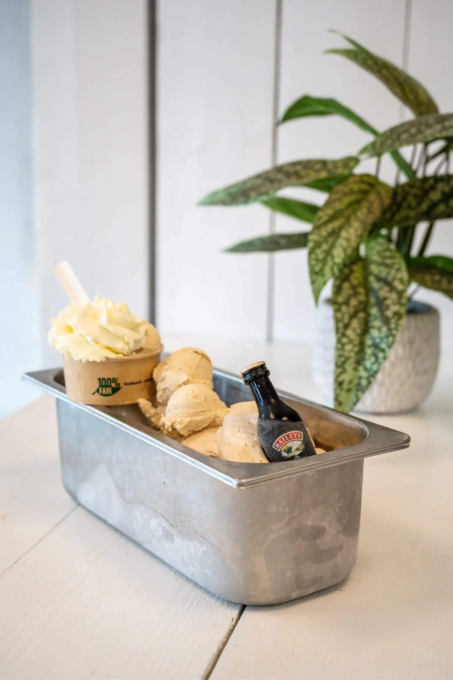 Corporate photo of a tub of ice cream with various toppings