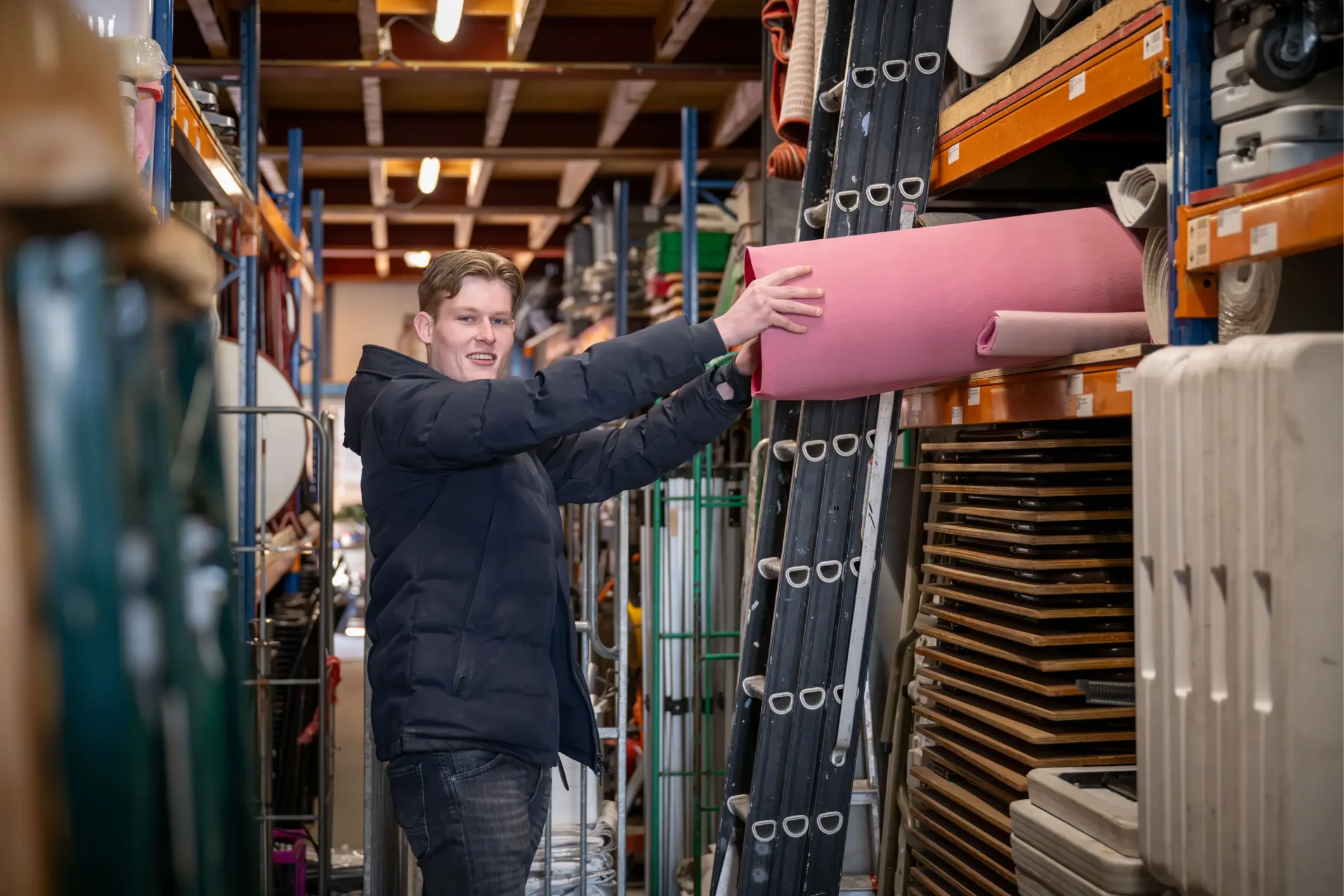 Corporate photo of a young man at work in a warehouse