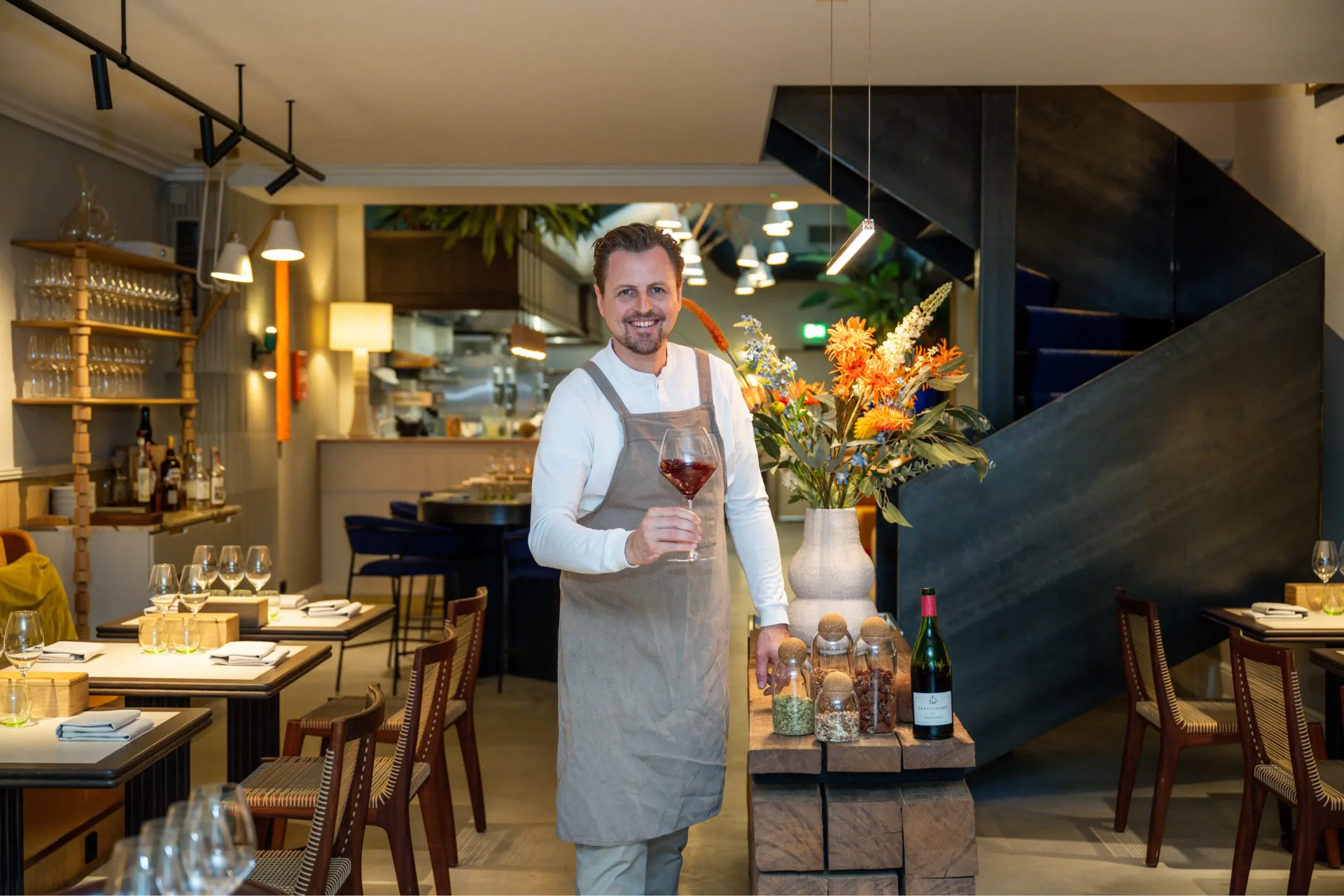 Corporate photo of a man holding a glass of wine