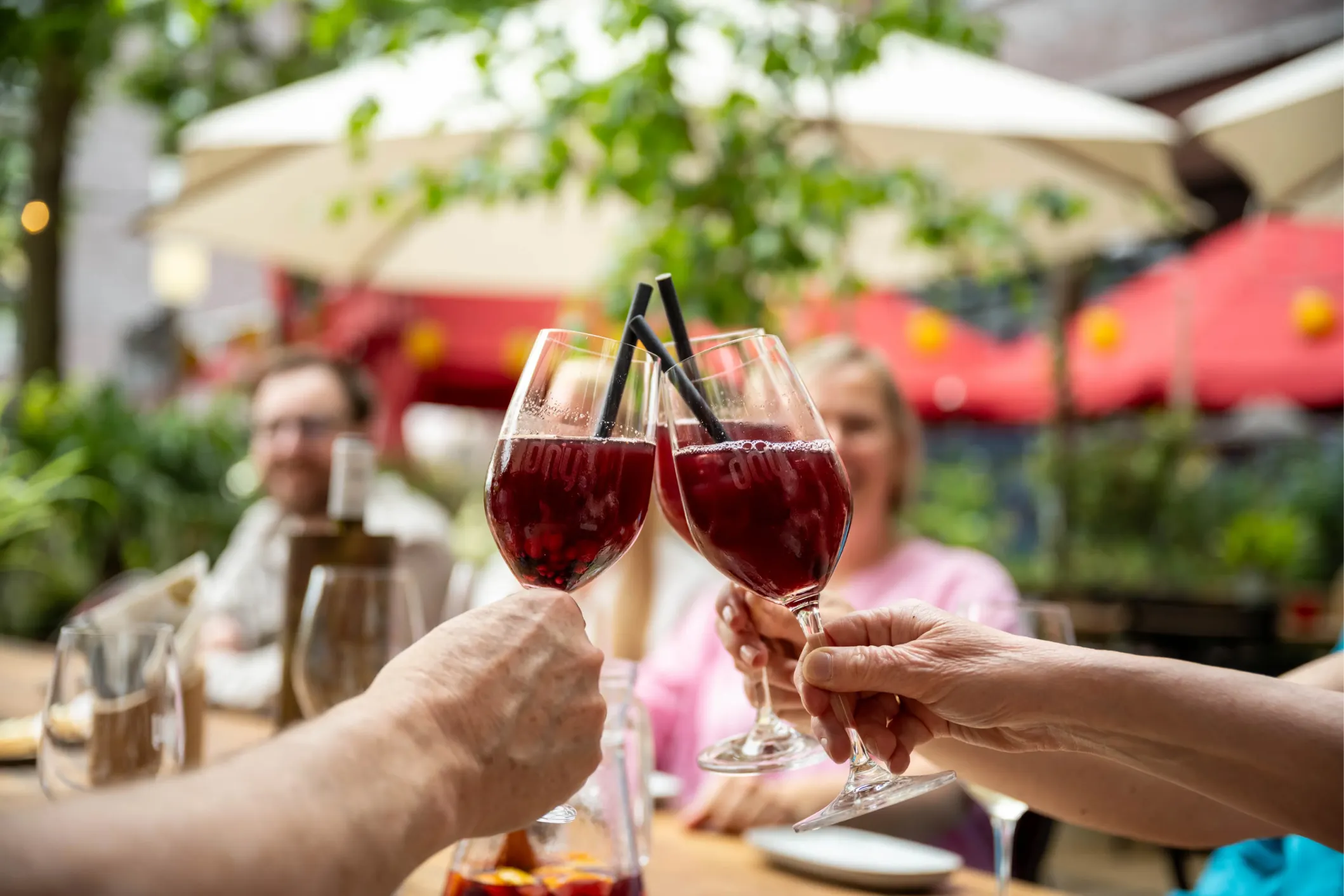 Corporate photo of people raising glasses of sangria in a toast