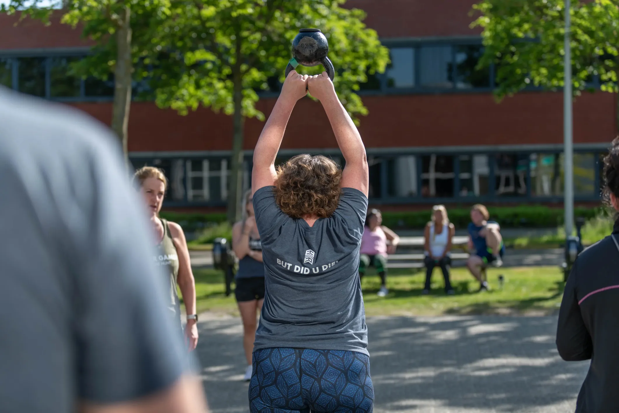 Event photo of women at an outdoor training, seen from behind