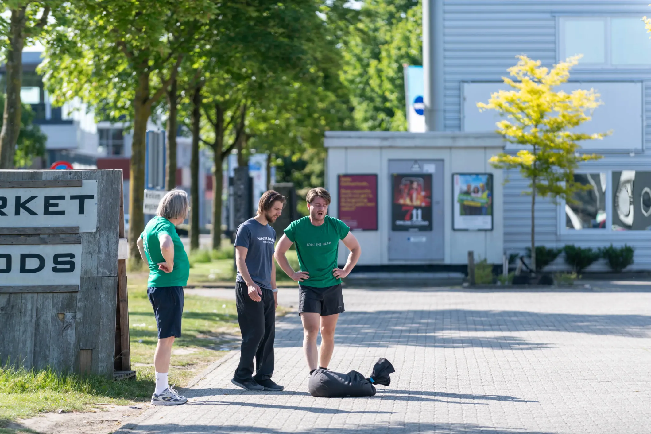 Event photo of men training outdoors with sandbags