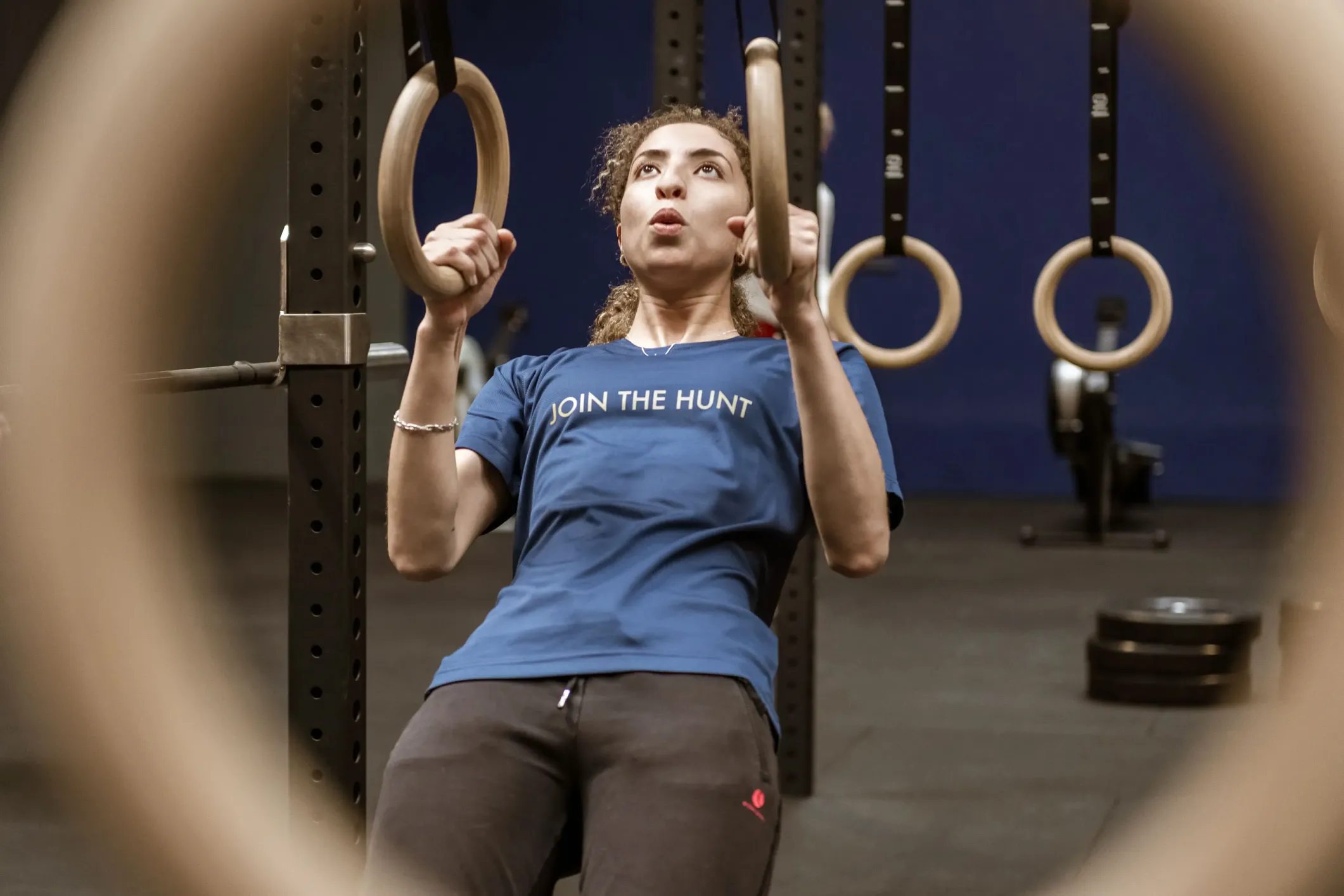 Event photo of a woman on the rings at CrossFit Hunters