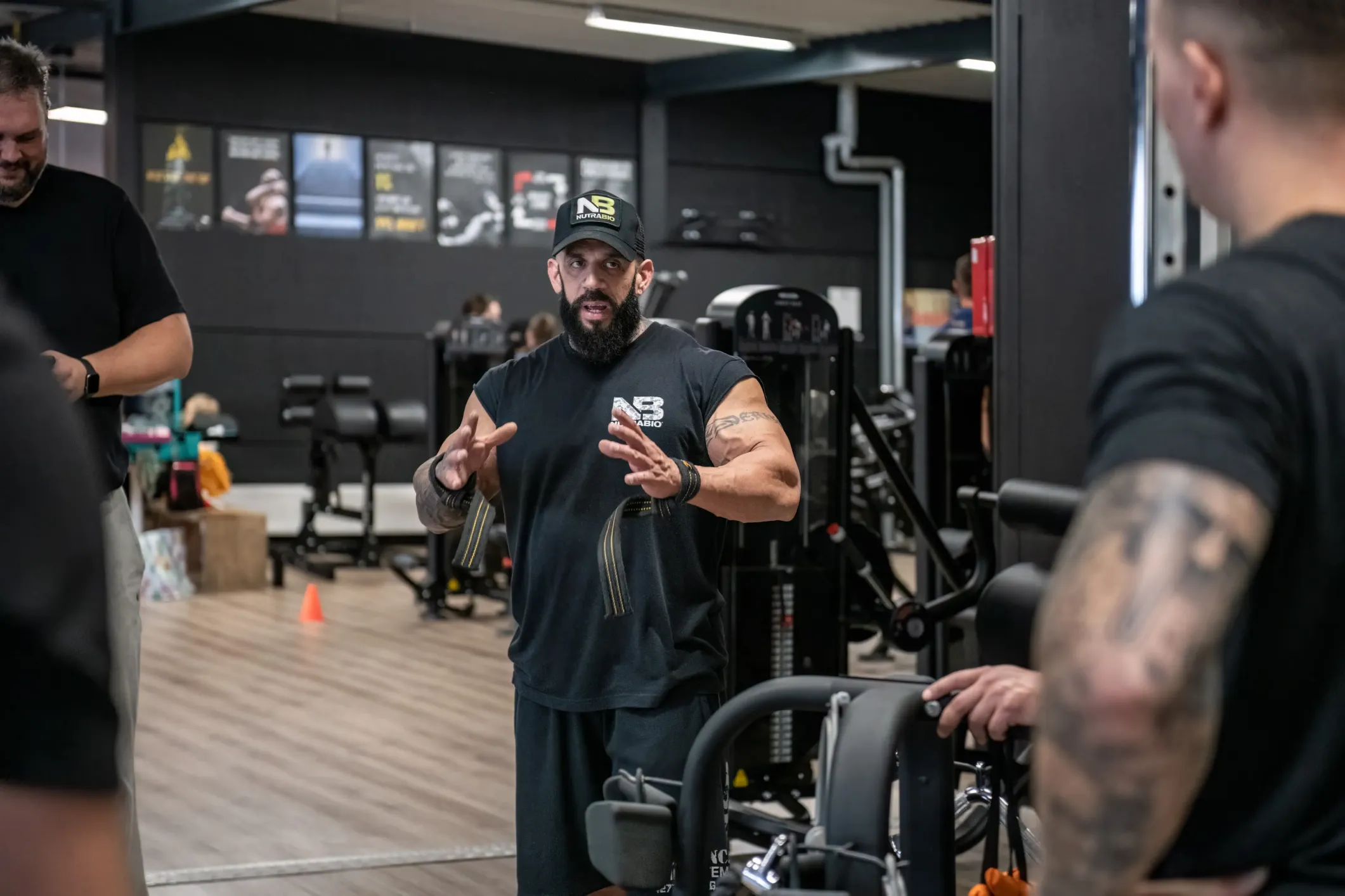 Event photo of a muscular man explaining an exercise