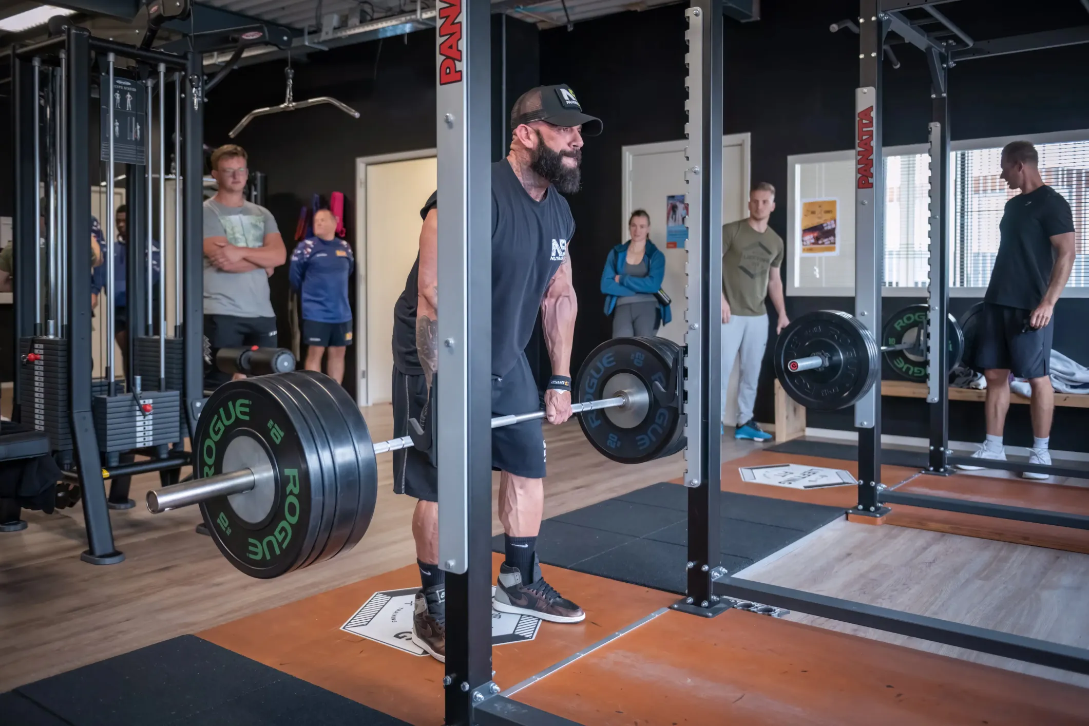 Event photo of a man deadlifting with Rogue plates