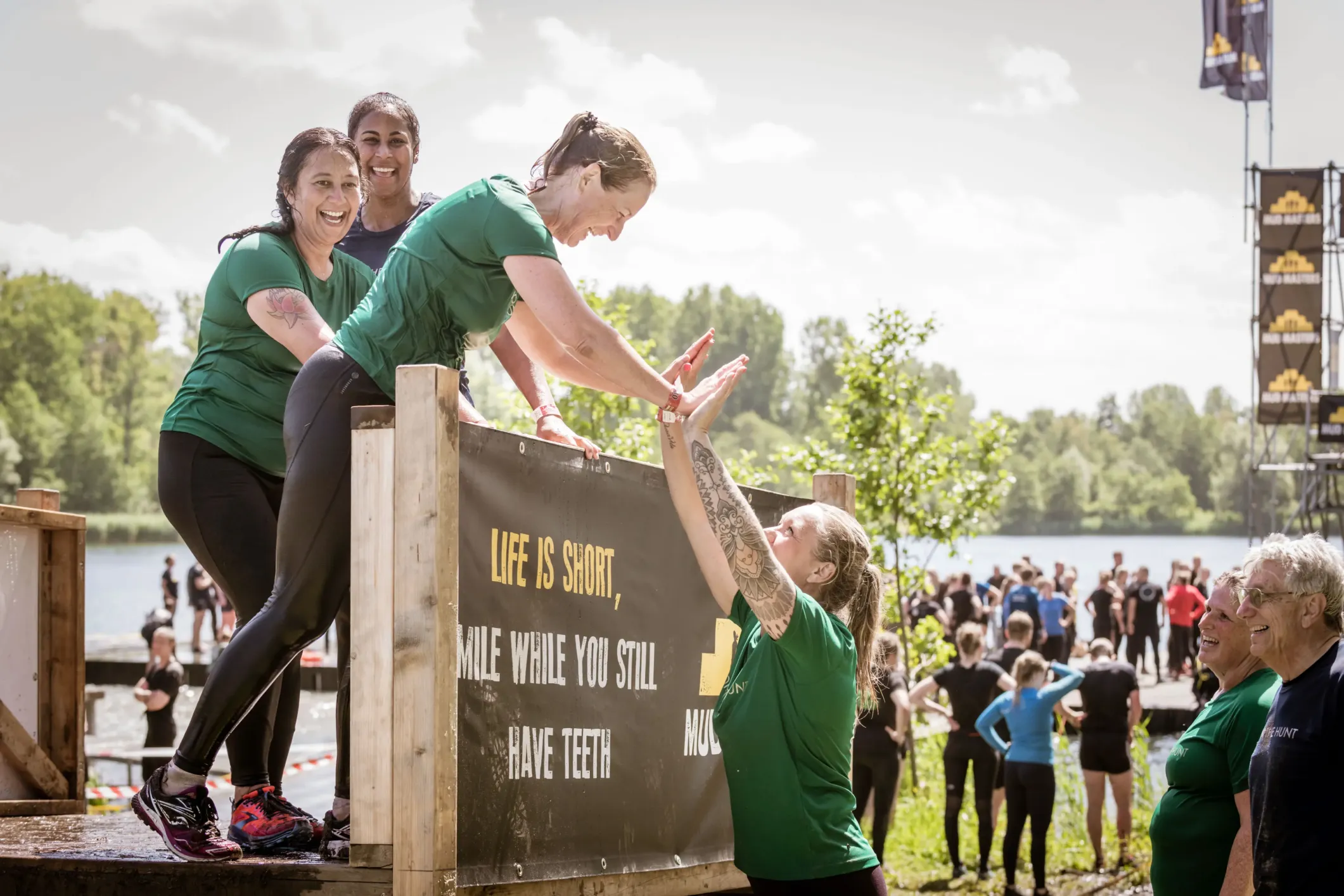 Event photo of women high-fiving each other at Mud Masters
