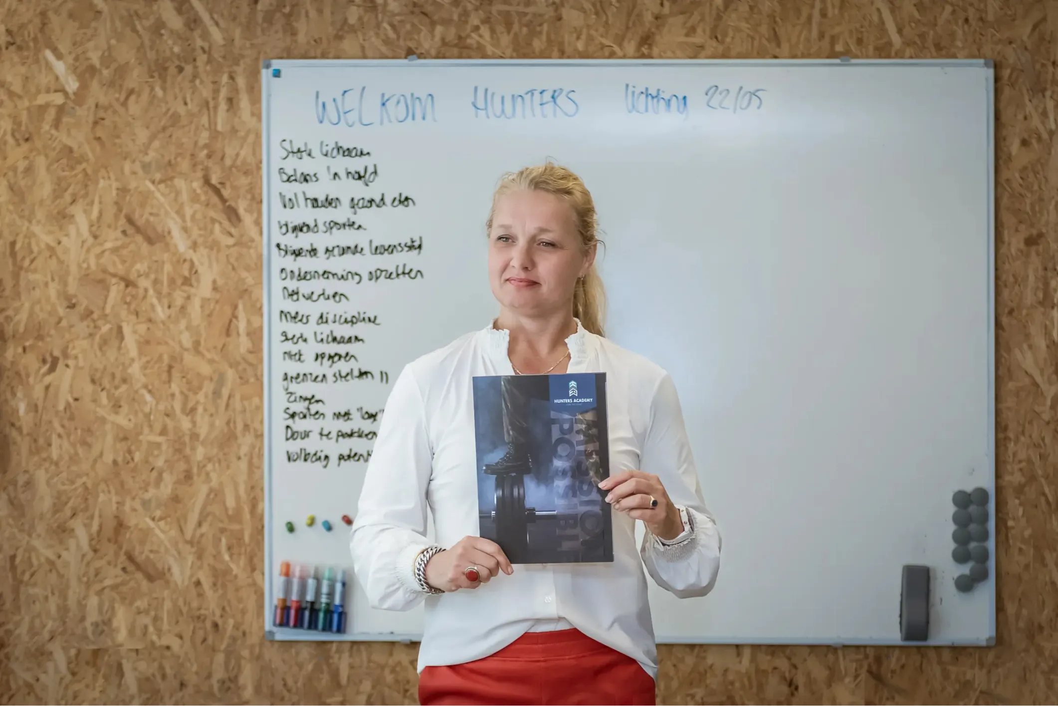 Event photo of a woman presenting a Hunters Academy booklet