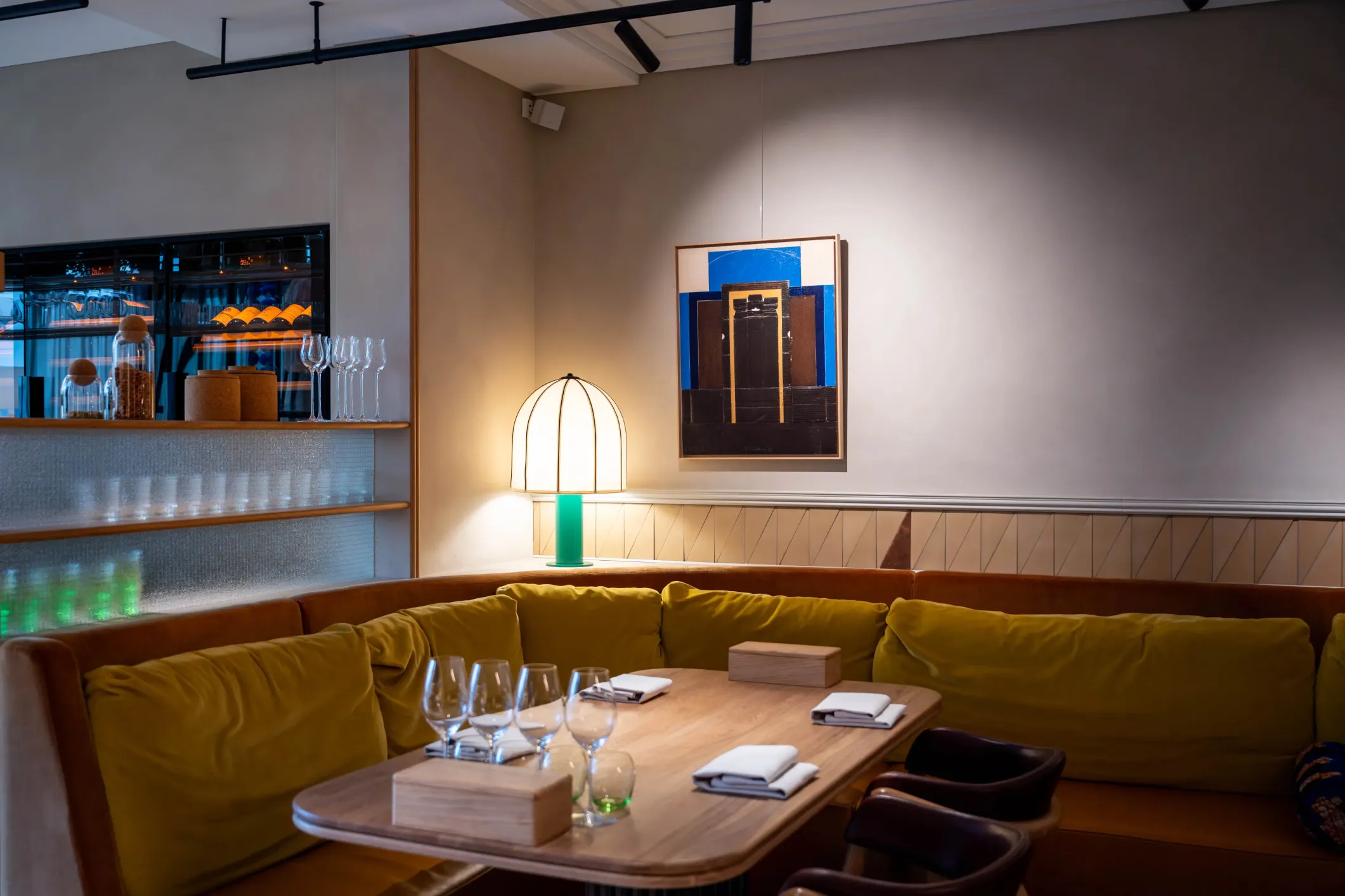 Interior photo of a restaurant with brown benches and a wooden table