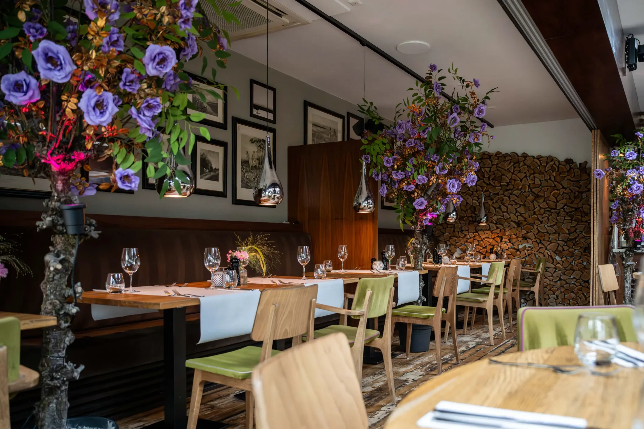 Interior photo of a restaurant with flowers and green chairs
