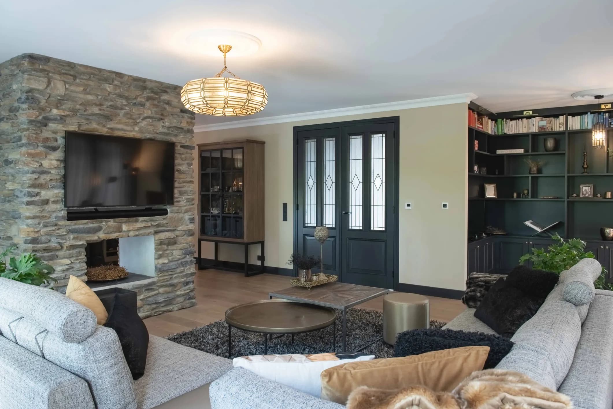 Interior photo of a living room with a coffee table, TV and white sofas
