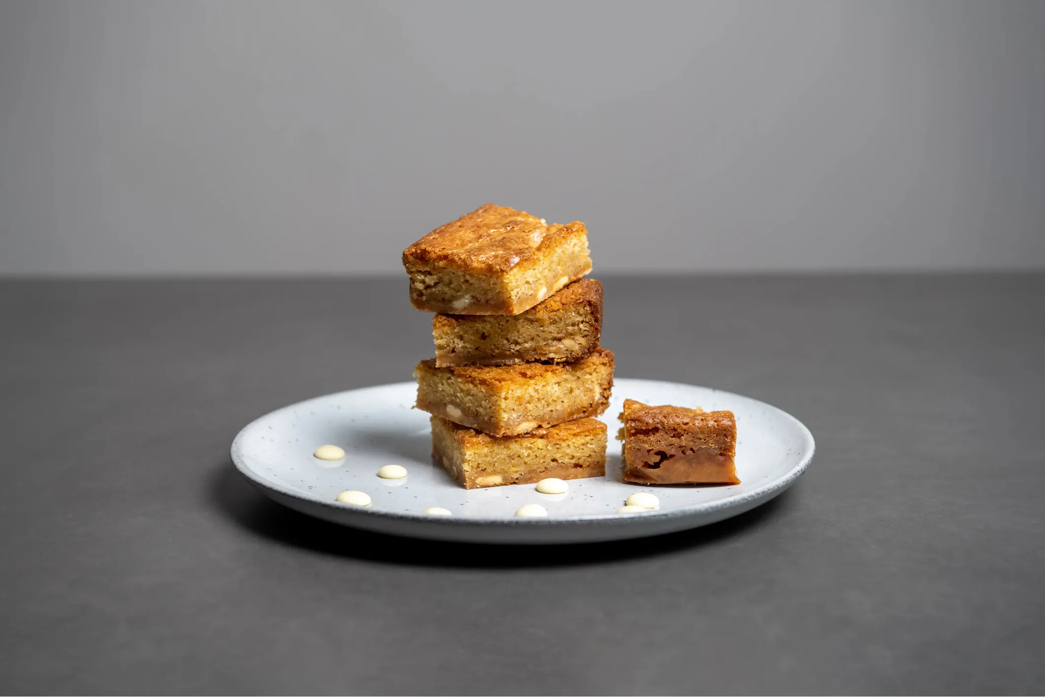 Product photo of stacked blondies on a white plate