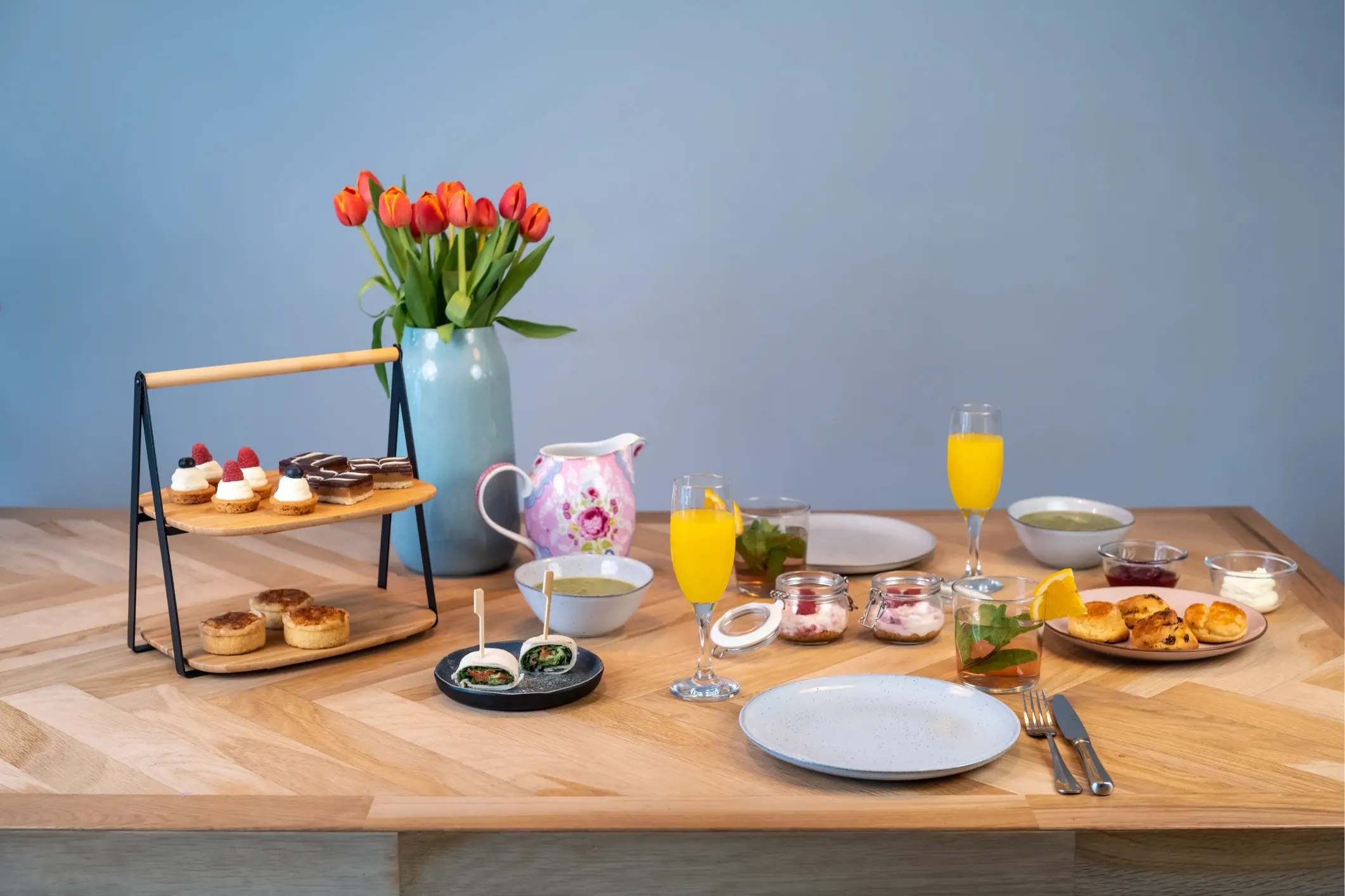 Product photo of a table set with high tea scones and wraps