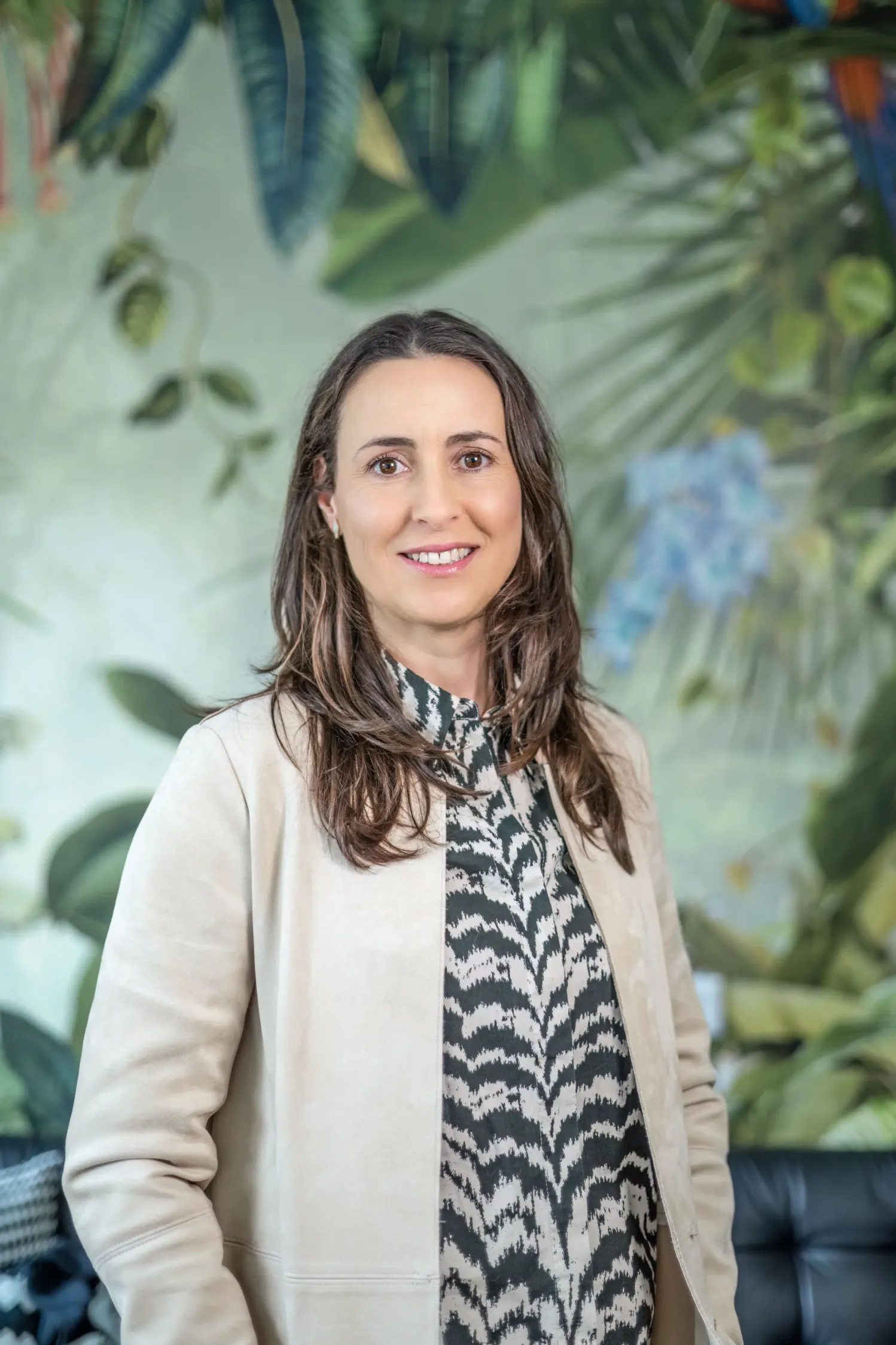 LinkedIn headshot of a smiling woman in a light blazer