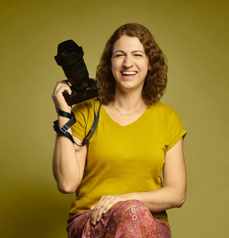 Joanna Vunderink smiling, with her camera in her hand